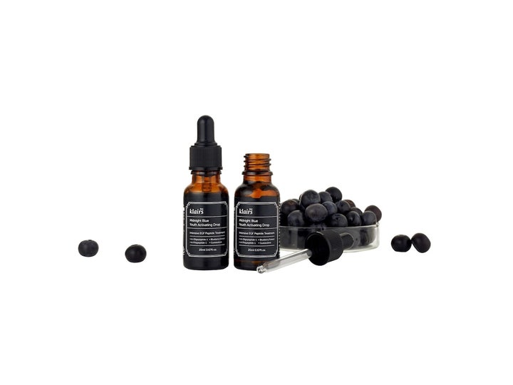 Klairs Midnight Blue Youth Activating Drop 20 ml serum i brune glasflasker med pipette og friske blåbær.