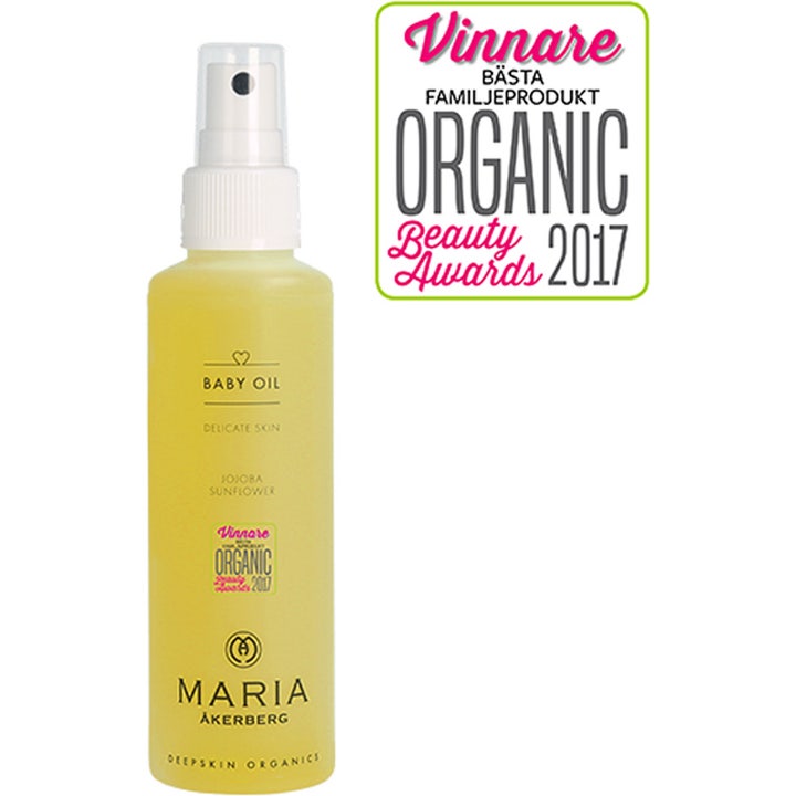 Maria Åkerberg Baby Oil plejende kropsolie til sart hud i gennemsigtig sprayflaske med gul olie og hvid pumpe.