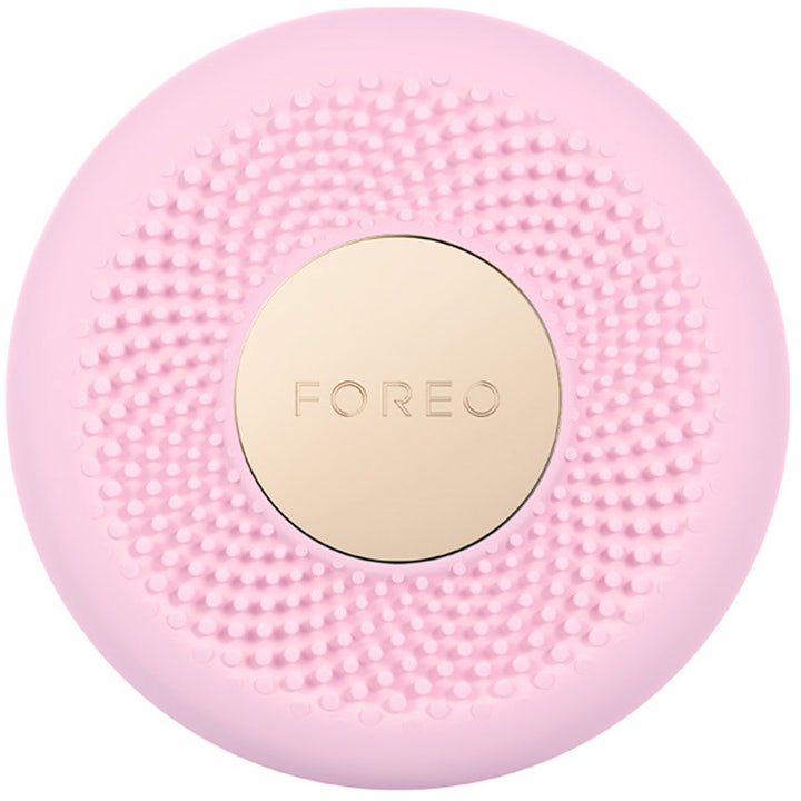 Foreo UFO ansigtsbehandling til fugtgivende pleje vist som en rund lyserød silikoneenhed med guldplade.