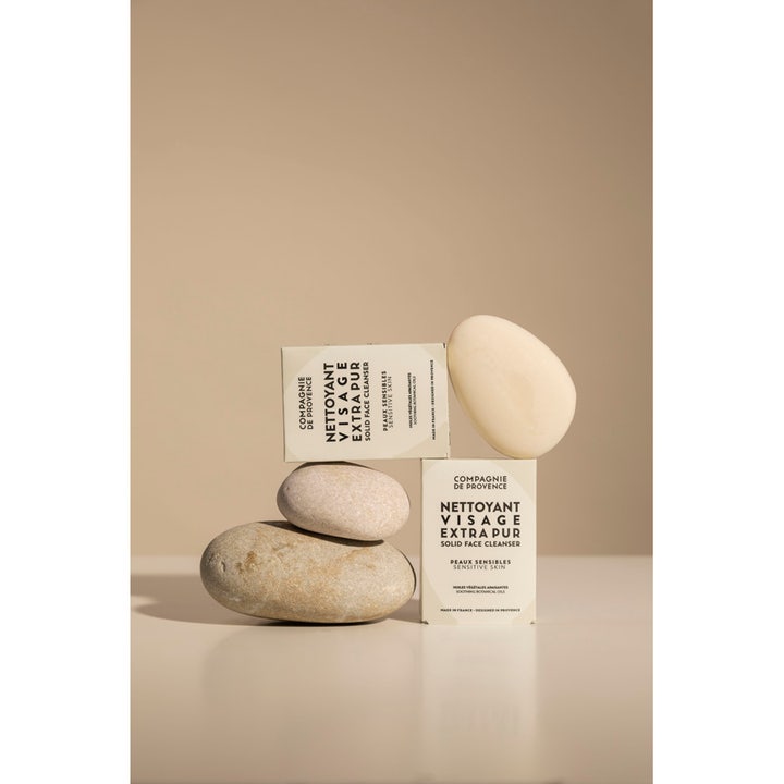 Compagnie de Provence Solid Face Cleanser 85 g beroligende ansigtsrens hvid bar og æske stylet med glatte natursten