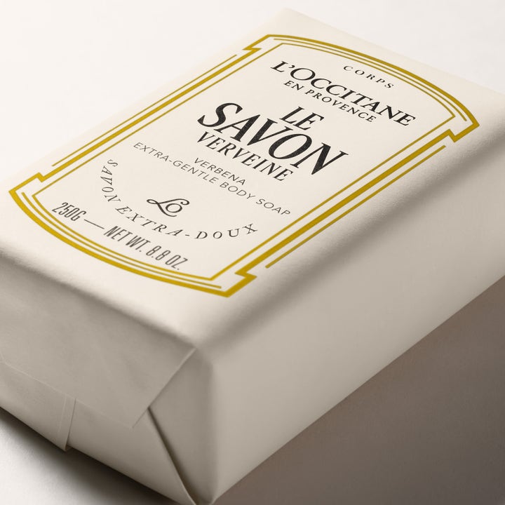L'Occitane Shea Butter Verbena Body Soap 250 g blødgørende kropssæbe i hvid papirindpakning med gul detalje.