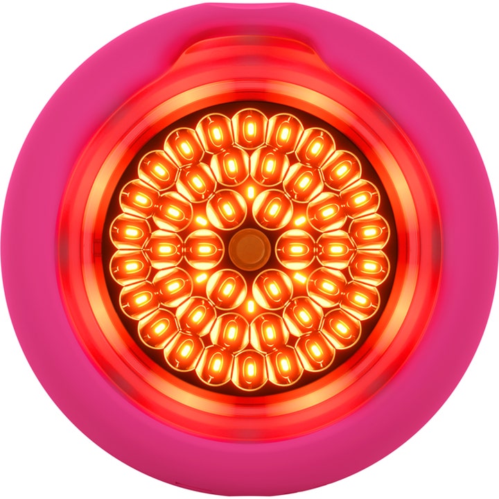 FOREO UFO ansigtsbehandling til LED-lysterapi i pink design med lysende gule dioder i cirkelmønster.
