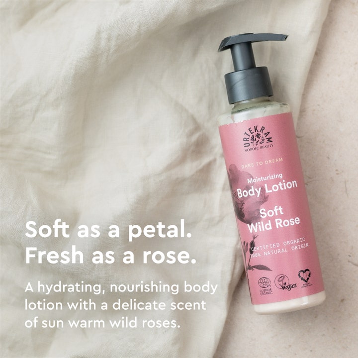 Urtekram Body Lotion Soft Wild Rose 245 ml fugtgivende bodylotion i pumpeflaske på linned med citatet Soft as a petal