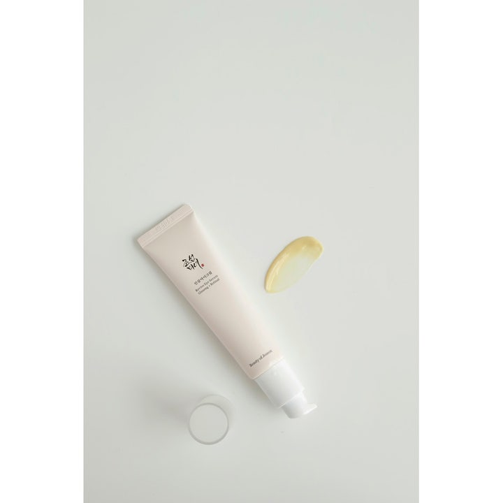 Beauty of Joseon Revive Eye Serum mod mørke rande i beige tube med pumpe og en gul cremet tekstur ved siden af