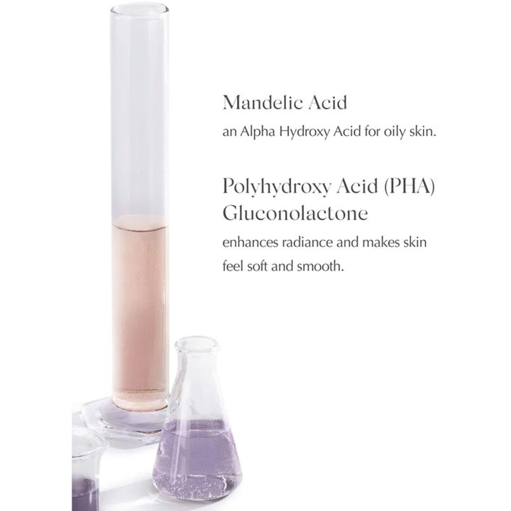 Exuviance Night Corrector 50 g nattcreme med Mandelic Acid og PHA i laboratorieglas der giver glød.