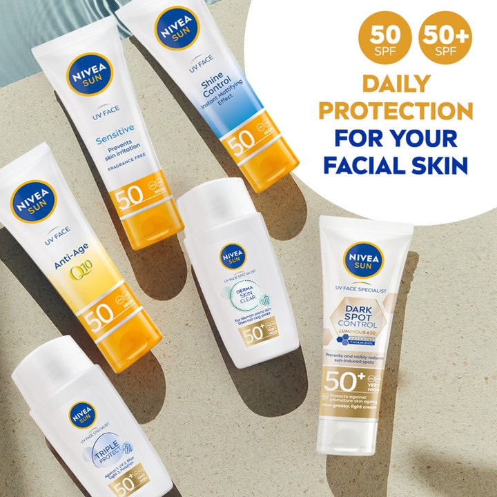 NIVEA Sun UV Face Shine Control Cream 50 ml solcreme i tube vist i et udvalg af ansigtssolcremer på en stenoverflade.