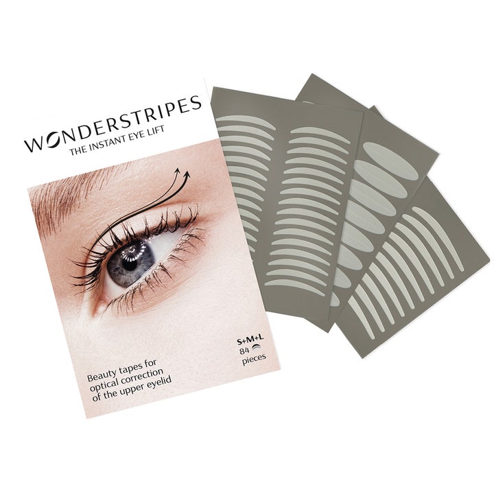 Wonderstripes Instant Eye Lift 84 stk øjenlågstape giver et løft vist med hvid emballage og tre grå ark med strips