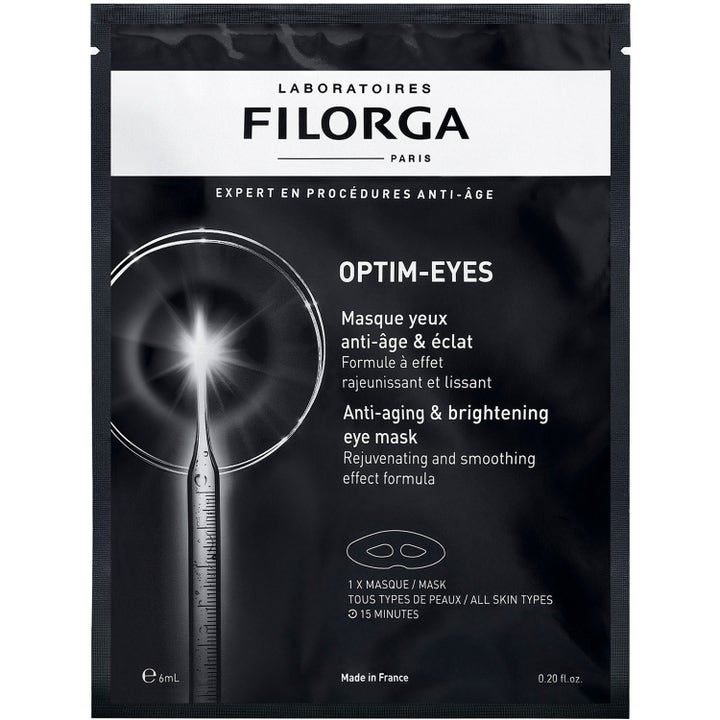 Filorga Optim-Eyes 6 ml øjenmaske mod mørke rande og linjer i en sort pose med grafik af en lysende pipette