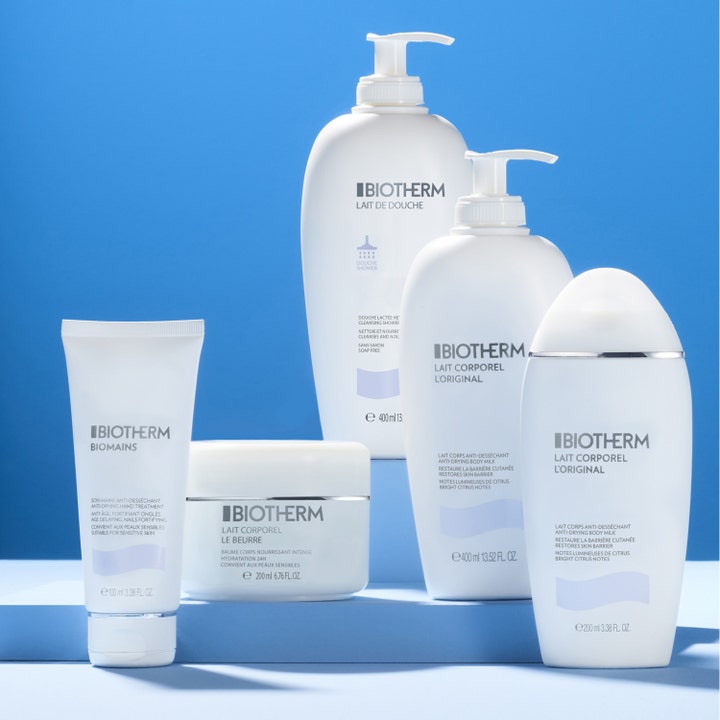 Biotherm Biomains 100 ml plejende håndcreme i tube vist sammen med andre hvide Biotherm kropsplejeprodukter