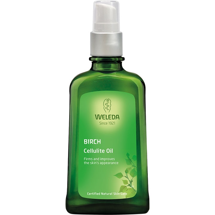 Weleda Birch Cellulite Oil opstrammende kropsolie mod appelsinhud i en grøn glasflaske med sølvfarvet pumpe