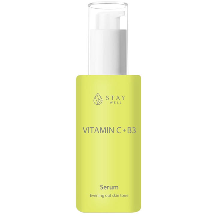 Stay Well Vitamin C + B3 Serum 30 ml udjævner hudtonen i en limegrøn flaske med hvid pumpe og klar hætte.