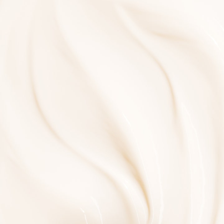 Biotherm Baume Corps Oil Therapy 400 ml fugtgivende bodylotion med en rig cremet hvid tekstur i bløde bølger