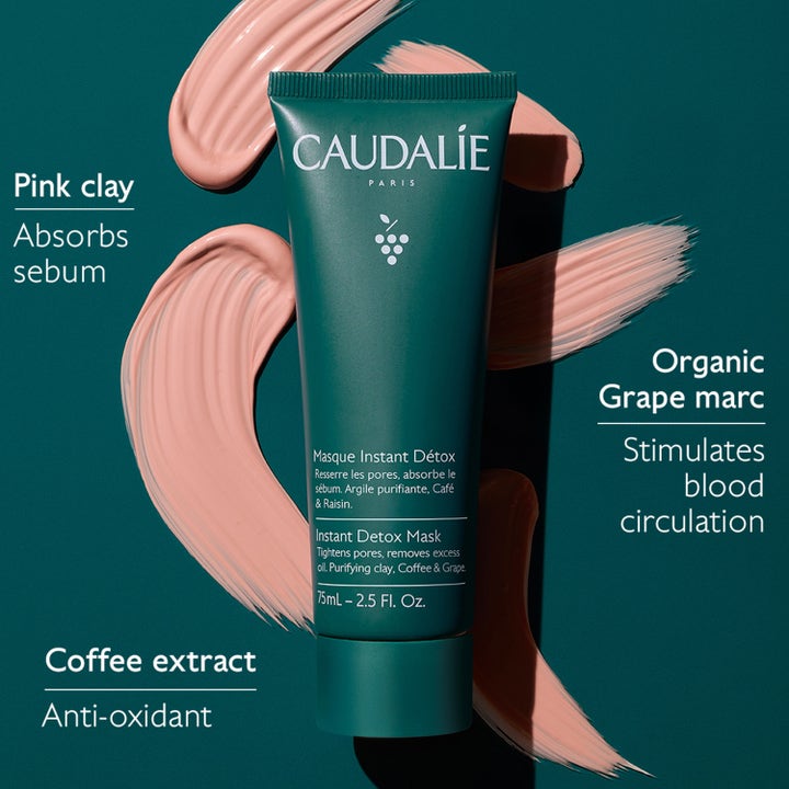 Caudalie Instant Detox Mask 75 ml rensende ansigtsmaske med pink clay i grøn tube omgivet af lyserødt ler.