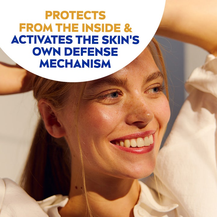 NIVEA UV Face Triple Protect Fluid 40 ml solcreme viser en smilende kvinde og tekst om at aktivere hudens eget forsvar.
