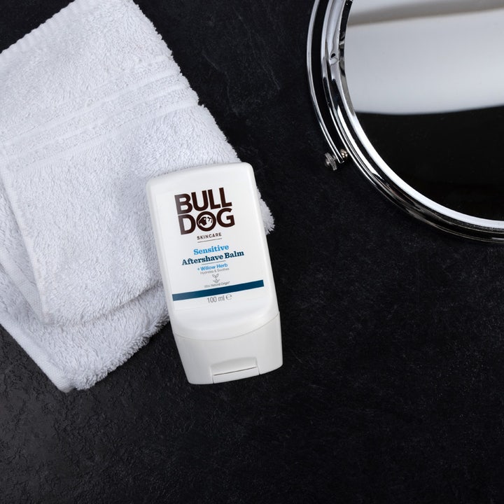 Bulldog Sensitive After Shave Balm 100 ml beroligende aftershave i hvid tube ved et hvidt håndklæde og et spejl