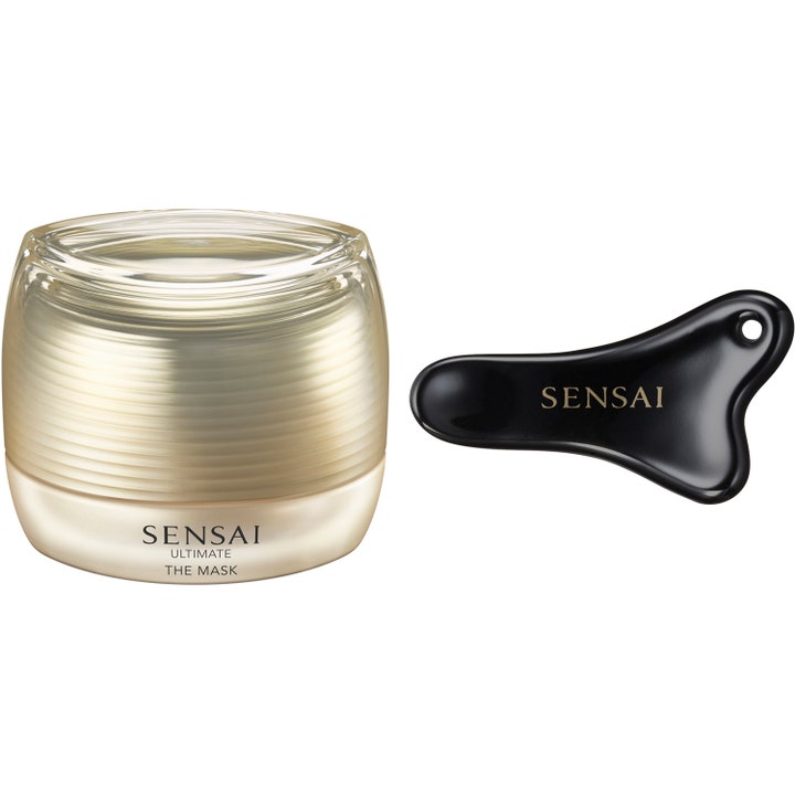 Sensai Ultimate The Mask 75ml ansigtsmaske i luksuriøs guldkrukke med sort massageværktøj.