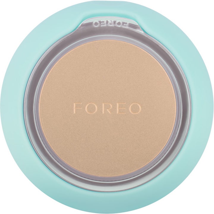 FOREO UFO 2 Mint ansigtsbehandling hudplejeenhed i mintgrøn silikone med en rund metalplade i guld