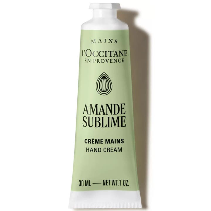 L'Occitane Amande Delicious Hands 30 ml blødgørende håndcreme i lysegrøn metaltube med sølvdetaljer og sort låg.
