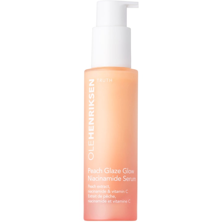 Ole Henriksen Peach Glaze Glow Niacinamide Serum glødgivende ansigtsserum i en ferskenfarvet frostet flaske med hvid pumpe