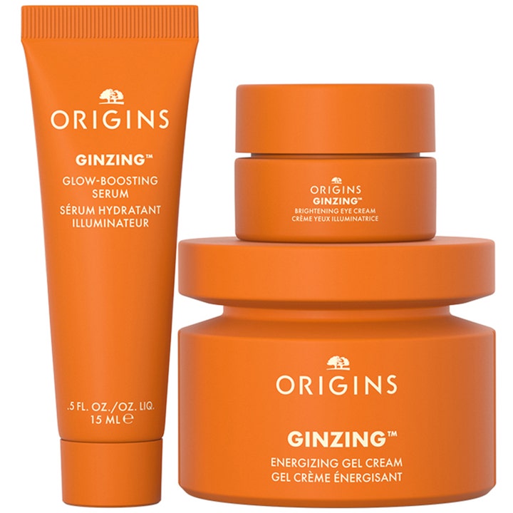 Origins The Glow-Boosting Collection 70 ml hudplejesæt med orange tube og krukker der giver huden glød.
