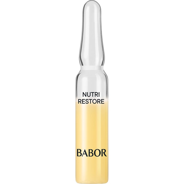 Babor Nutri Restore genopbyggende ansigtspleje i en gennemsigtig glasampul med gult serum og sort tekst