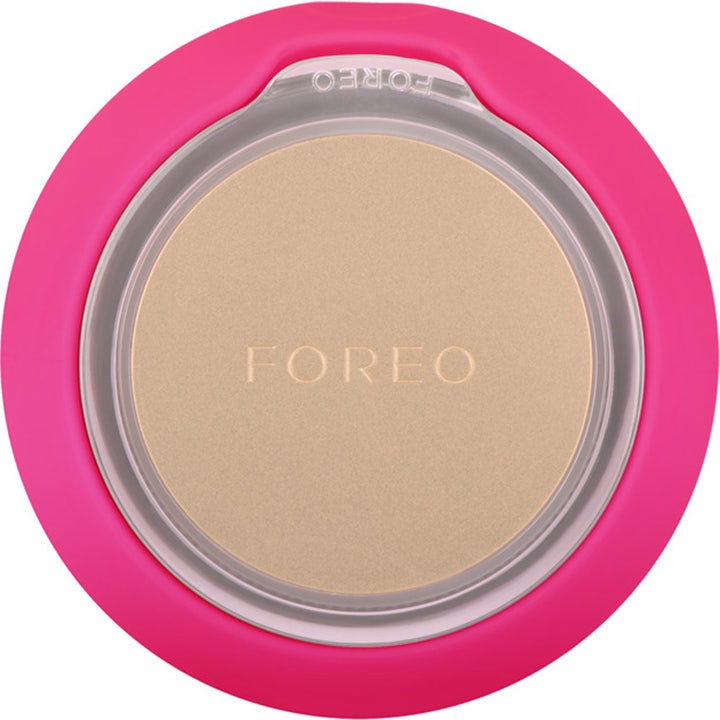 FOREO UFO mini 2 Fuchsia hudplejeenhed med fuchsia silikone og en rund guldplade til effektiv ansigtsbehandling