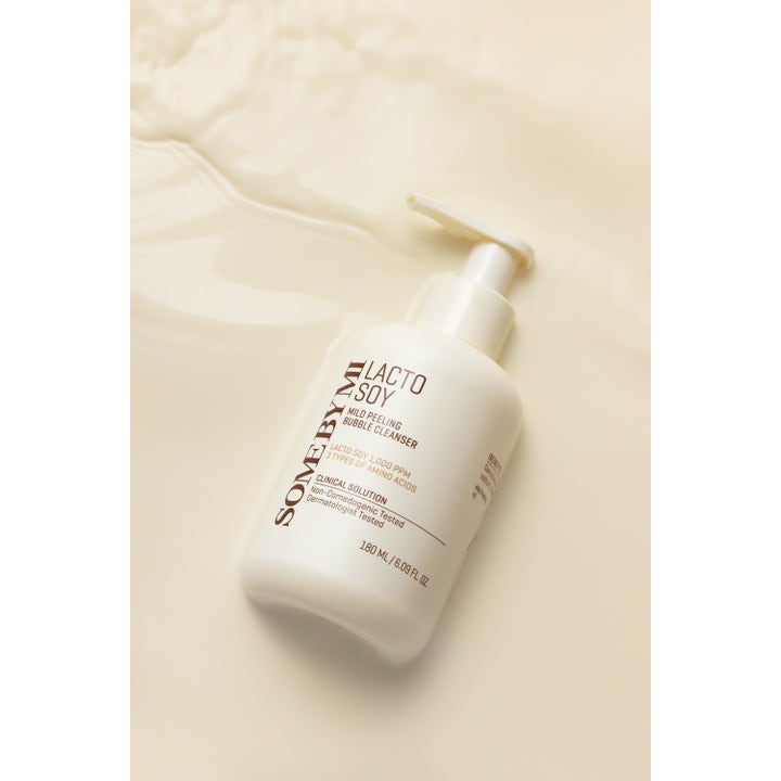 Some By Mi Lactosoy Mild Bubble Peeling Cleanser 180 ml eksfolierende ansigtsrens i hvid pumpeflaske på cremet baggrund