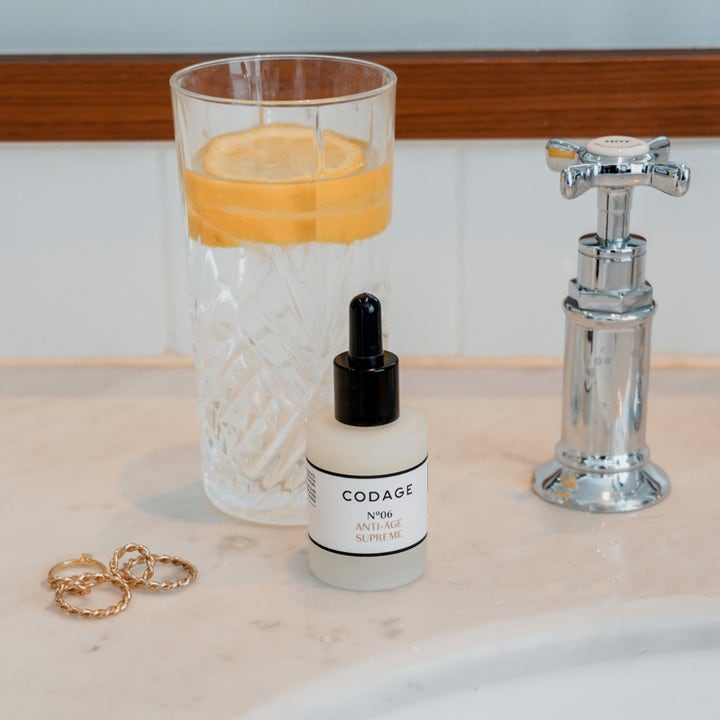 Codage Paris The Serum N°06 Anti-Aging Supreme 30 ml anti-age serum i frostet glasflaske ved siden af citronvand