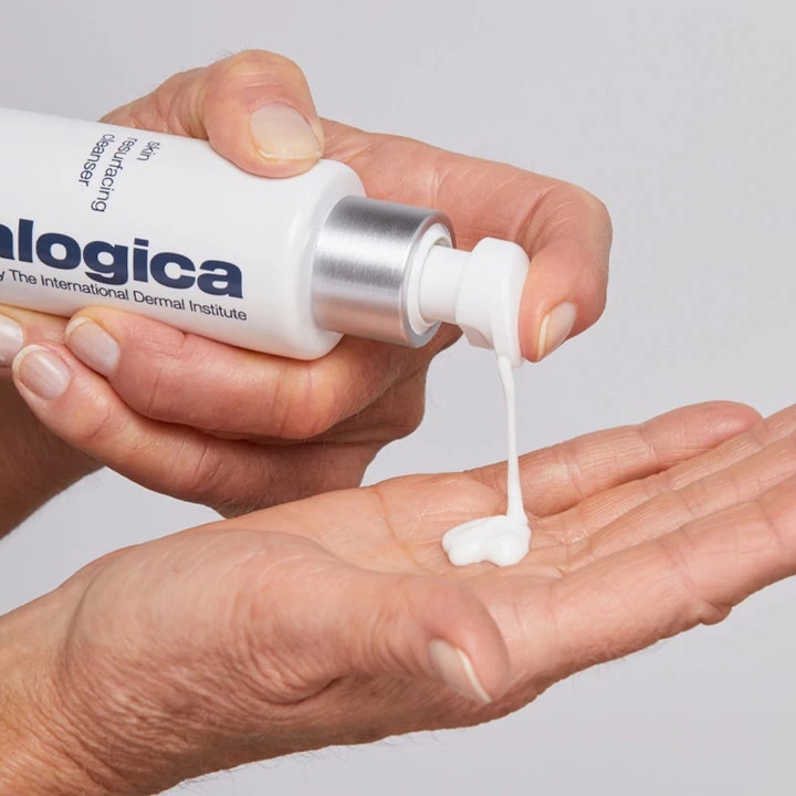 Dermalogica AGE smart Skin Resurfacing Cleanser 150 ml eksfolierende ansigtsrens med hvid cremet tekstur i hånden.