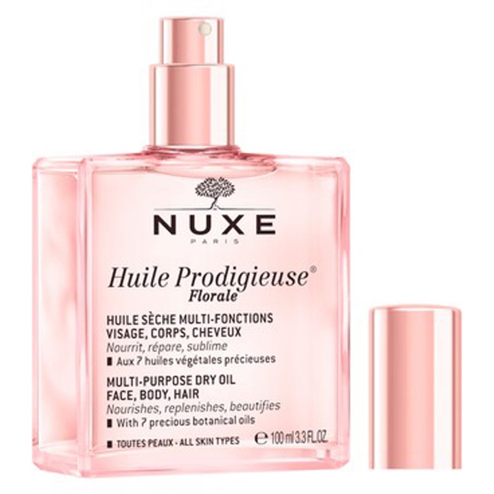 Nuxe Huile Prodigieuse Florale 100 ml tørolie plejer huden i lyserød glasflaske med elegant rosaguld spraypumpe.