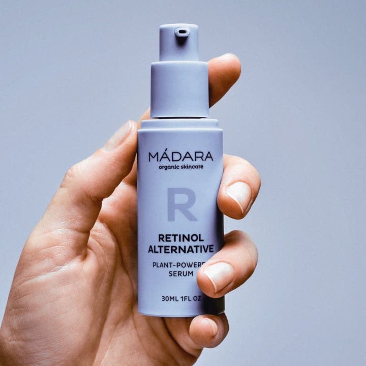 MÁDARA Retinol Alternative Serum 30 ml i lilla pumpeflaske der holdes af en hånd og reducerer rynker.