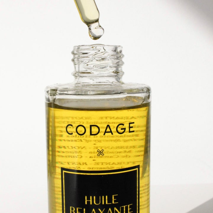 Codage Paris Relaxing Oil 100 ml beroligende kropsolie i glasflaske med en pipette der drypper gylden olie
