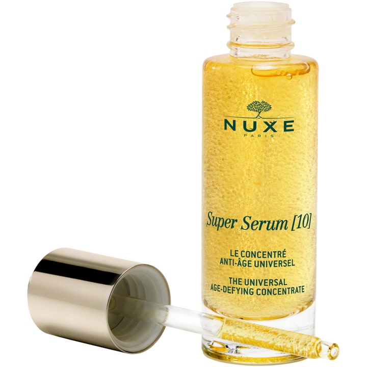Nuxe Super Serum 30 ml anti-aging serum med gyldne mikrokugler i en åben glasflaske med pipette.