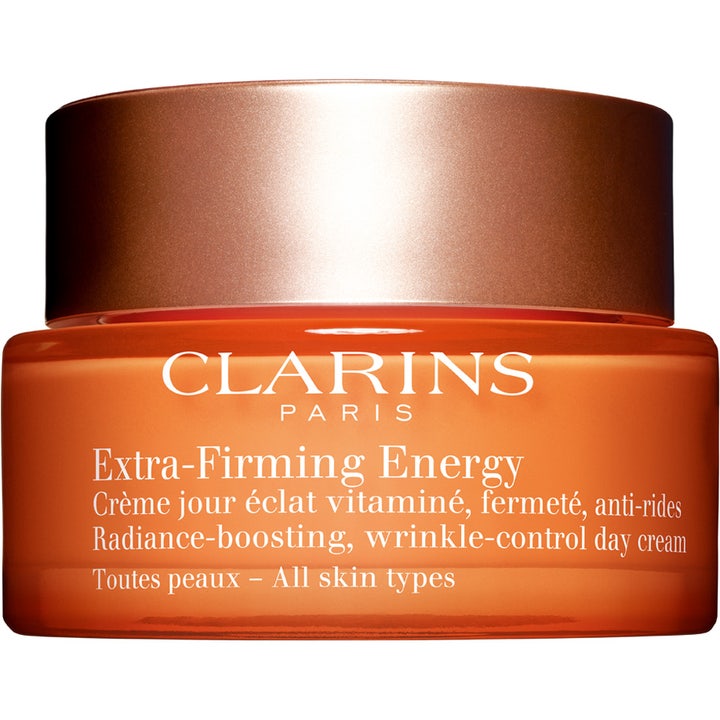 Clarins Extra-Firming Energy 50 ml dagcreme giver glød og fasthed i en orange glaskrukke med bronzefarvet låg.