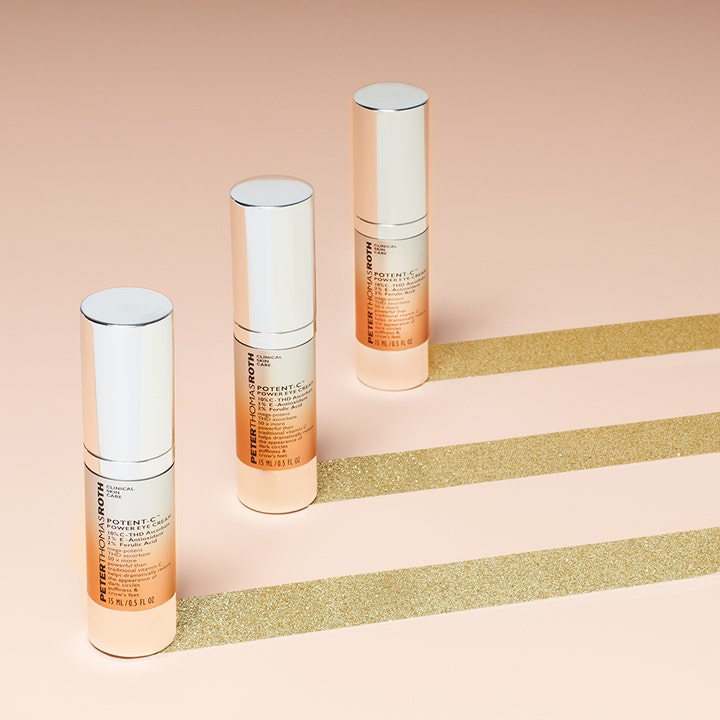 Peter Thomas Roth Potent C Eye Cream 15 ml øjencreme mod mørke rande vist i tre pumper på baggrund med guldglimmer.