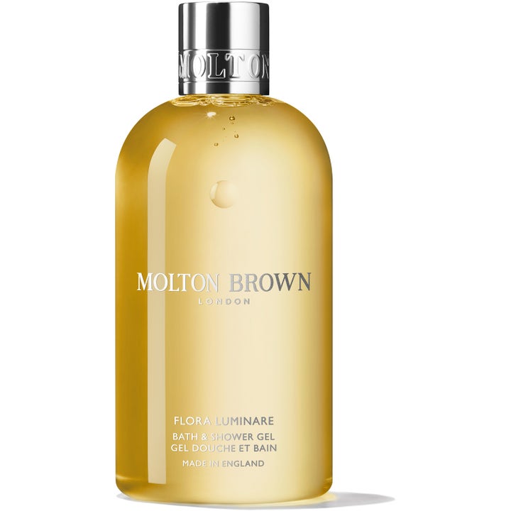 Molton Brown Flora Luminare 300 ml velduftende kropsvask med gylden gel i gennemsigtig flaske med elegant sølvlåg