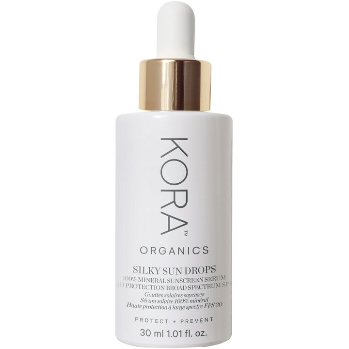 Kora Organics Silky Sun Drops 30 ml beskyttende solserum i hvid flaske med guldhætte og hvid pipette