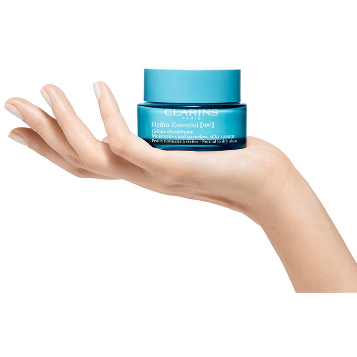 Clarins Hydra-Essentiel 50 ml ansigtscreme der fugter i blå glaskrukke holdt af en hånd