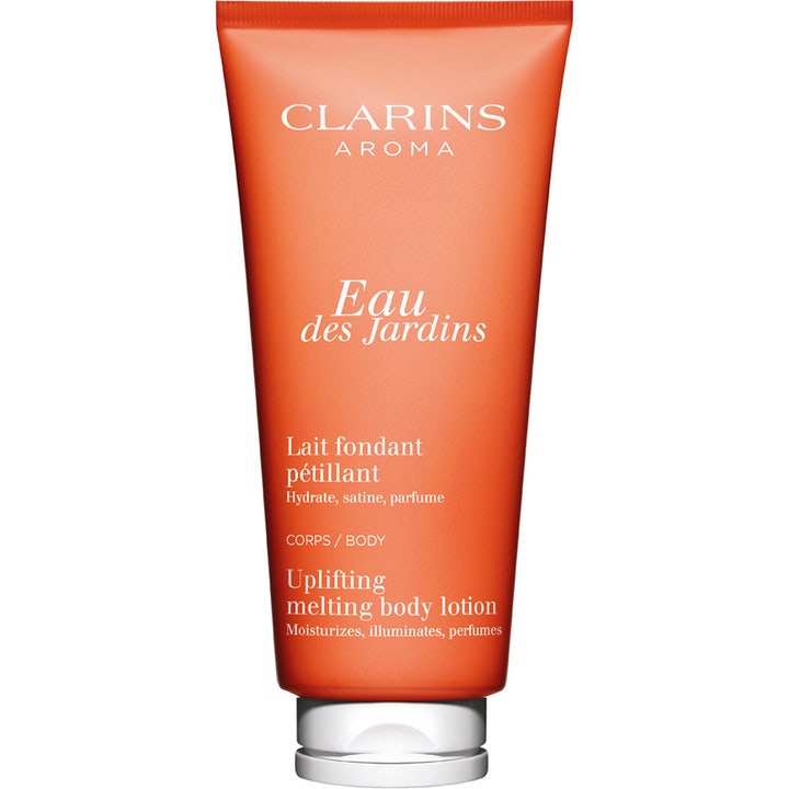 Clarins Eau des Jardins Uplifting Melting Body Lotion fugtgivende bodylotion i en klar orange tube med hvidt låg