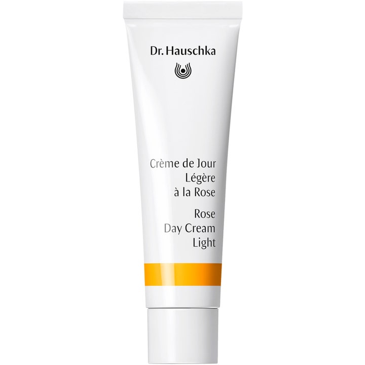 Dr. Hauschka Rose Day Cream Light beroligende ansigtscreme i hvid tube med orange detalje og hvidt låg.