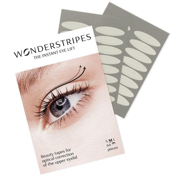 Wonderstripes The Instant Eye Lift 64 stk øjenlågstape der giver et øjneløft vist med ark af ovale gennemsigtige tapes.