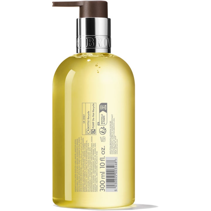 Molton Brown Orange & Bergamot 300 ml håndsæbe i gennemsigtig flaske viser bagsideetiket med ingredienser.