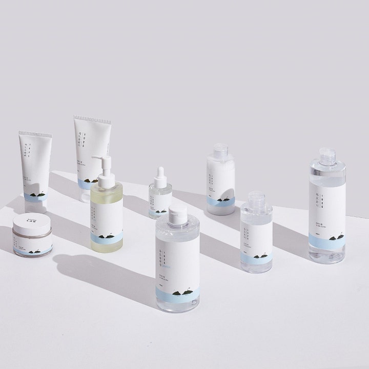 Round Lab 1025 Dokdo Toner 100 ml fugtgivende toner i en gruppe af hvide flasker og tuber med blå illustrationer