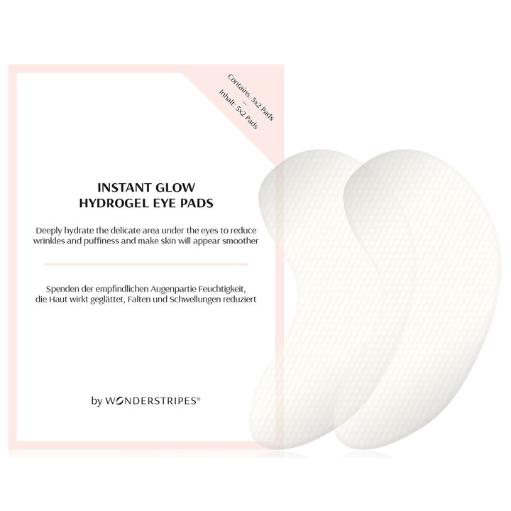 Wonderstripes Instant Glow Hydrogel Eye Pads 5x2 stk mod hævelser viser to hvide teksturerede pads og lyserød æske