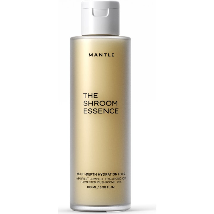 MANTLE The Shroom Essence 100 ml fugtgivende ansigtsessens med PHA i en frostet flaske med gylden væske og hvidt låg