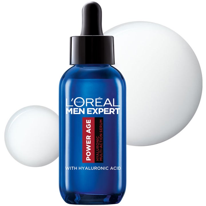L'Oréal Paris Men Expert Power Age Serum 30 ml i blå glasflaske med pipette mod hvide teksturbobler