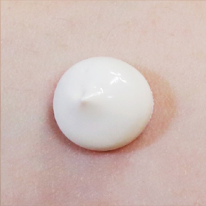 Suntique I'm Tone Up Multi Base 50 ml solcreme viser en hvid cremet tekstur der giver en jævn hudtone