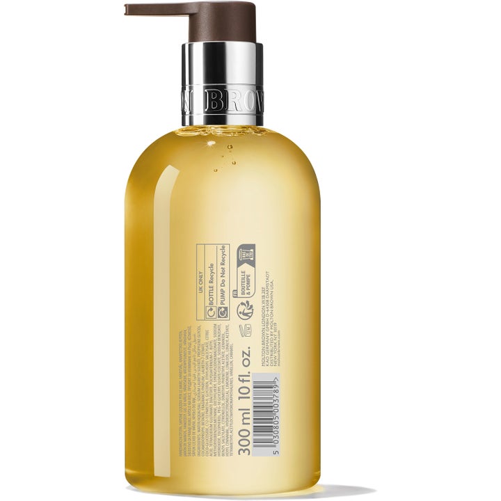 Molton Brown Flora Luminare Fine Liquid Hand Wash 300 ml håndsæbe set bagfra med gylden væske og ingrediensliste.