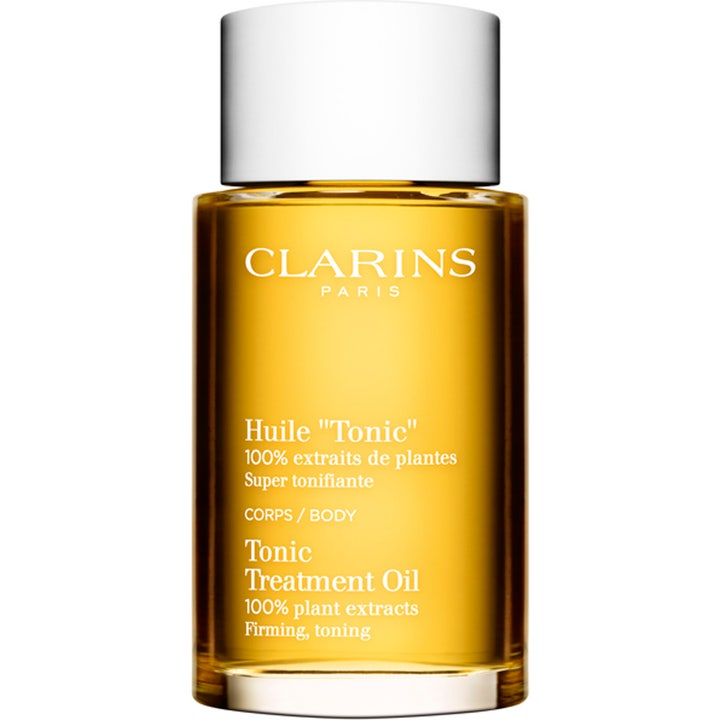 Clarins Tonic Treatment Oil 100 ml opstrammende kropsolie i klar glasflaske der viser den gyldne olie og hvidt låg
