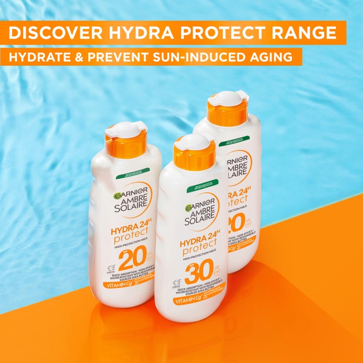 Garnier Ambre Solaire Hydra 24H Protect solcreme 175 ml i hvide flasker ved en pool der giver fugt